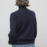 Back view of dark navy kensington top on model wearing jeans, against a white background.