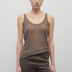 Front view of khaki kazu top on model wearing khaki pants, against a white background.