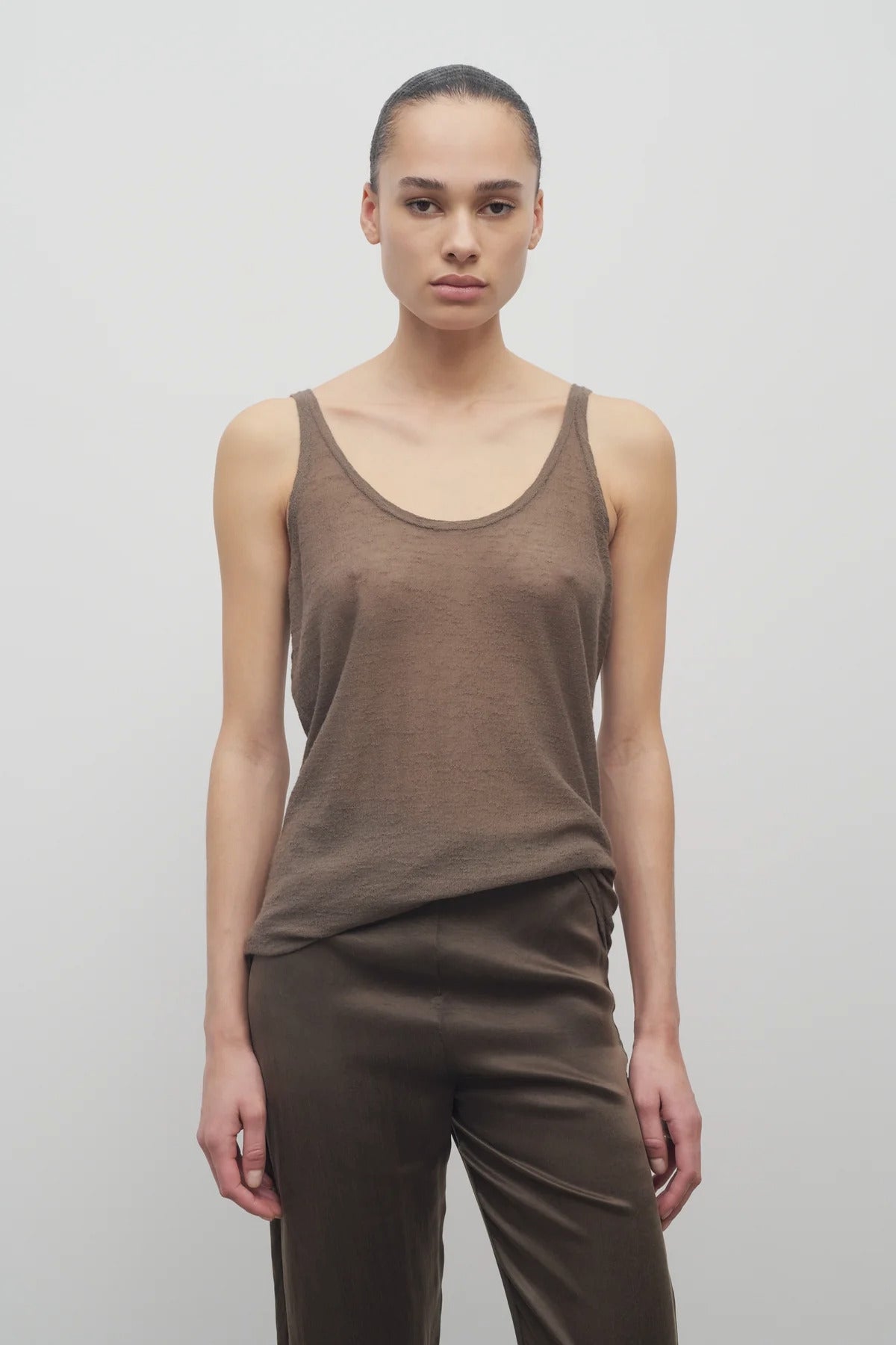 Front view of khaki kazu top on model wearing khaki pants, against a white background.
