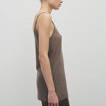 Side view of khaki kazu top on model wearing khaki pants, against a white background.