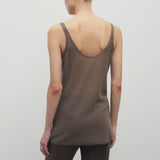 Back view of khaki kazu top on model wearing khaki pants, against a white background