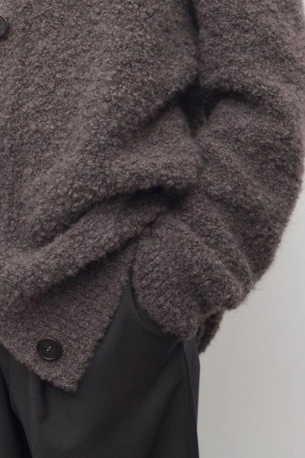 Front closeup view of taupe laleh cardigan on model wearing charcoal pants, against a white background.