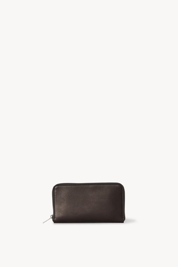 Front view of dark brown large zip wallet on white background, with no model shown.