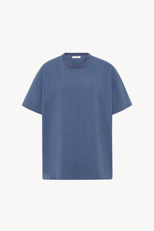 A light blue cotton T-Shirt is pictured against a white backdrop, shown without model