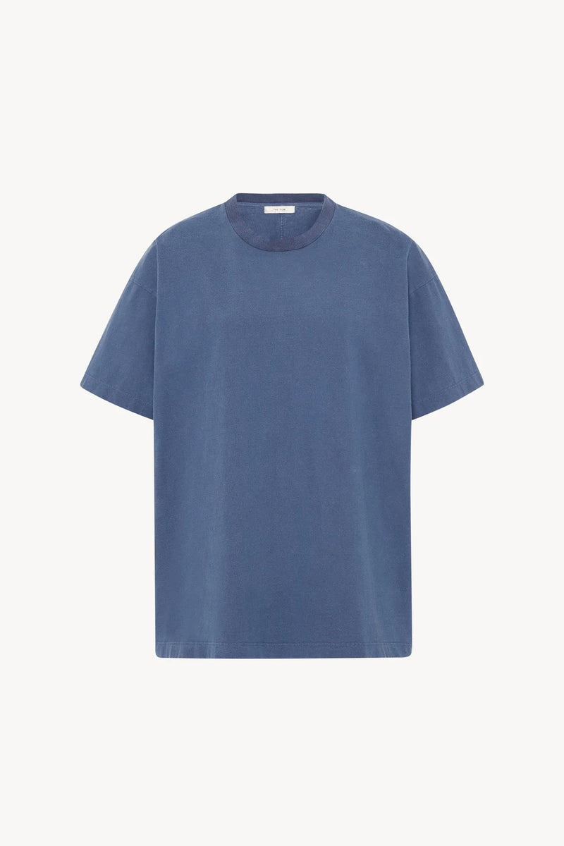 A light blue cotton T-Shirt is pictured against a white backdrop, shown without model