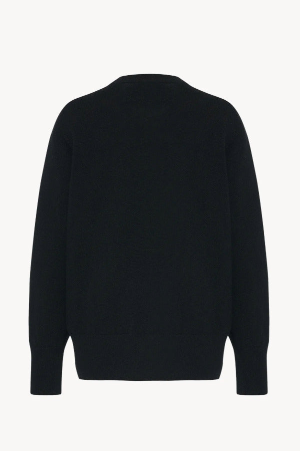Back view of black leilani top on white background, with no model shown.