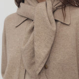 Front view of Taupe Leomine Scarf on model wearing Taupe sweater, against white background.