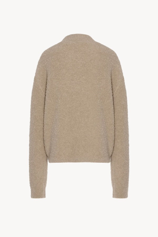 Back view of beige lethara sweater on white background, with no model shown.