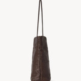 Side view of brown lilou woven tote on white background, with no model shown.