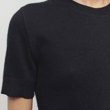Front closeup view of black linnea sweater on model against a white background.