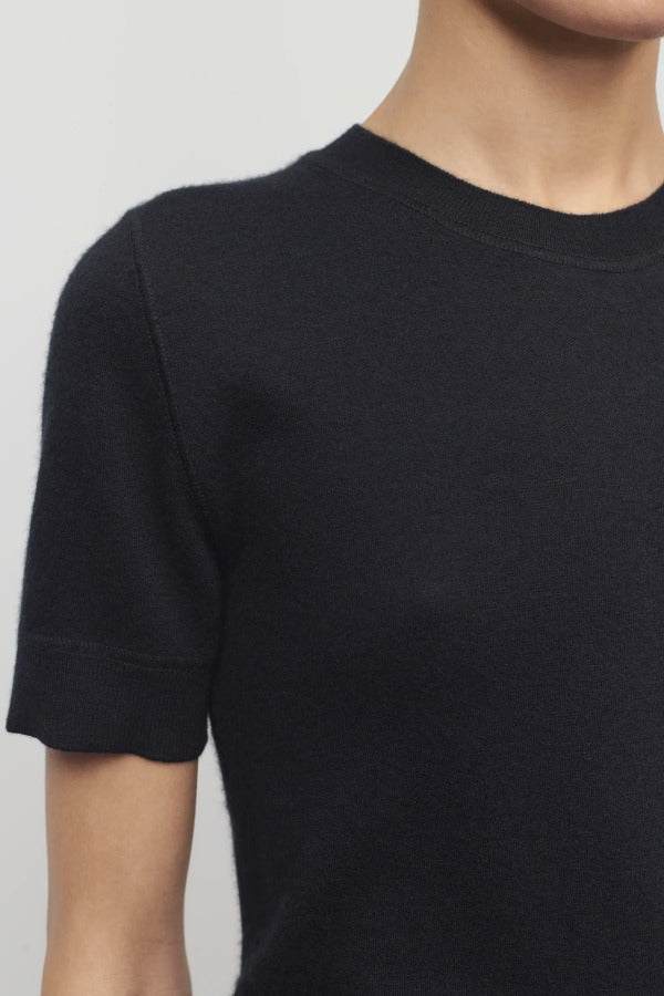 Front closeup view of black linnea sweater on model against a white background.