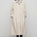 Front view of porcelain lolana coat on model wearing black oxfords, against a white background.