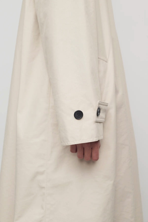 Side closeup view of porcelain lolana coat on model, against a white background.