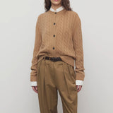 Front view of fawn loneke cardigan on model wearing camel pants, against a white background.