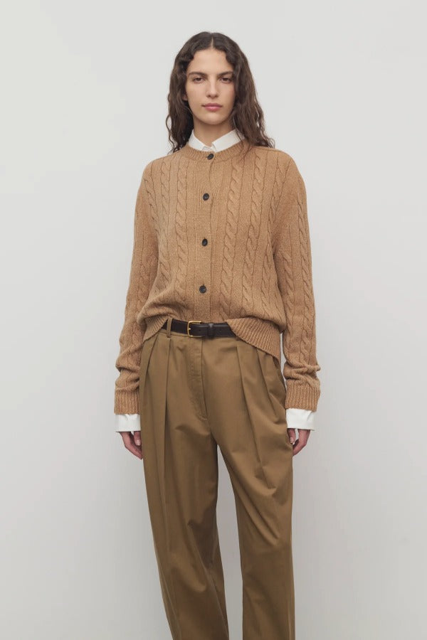 Front view of fawn loneke cardigan on model wearing camel pants, against a white background.