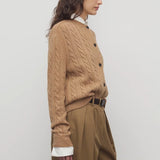 Side view of fawn loneke cardigan on model wearing camel pants, against a white background.