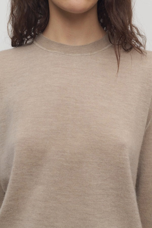 Front closeup view of beige melange lorelei sweater on model against a white background.