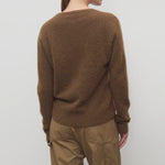 Back view of oak lorynna top on model wearing camel trousers, against a white abckground.