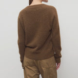 Back view of oak lorynna top on model wearing camel trousers, against a white abckground.