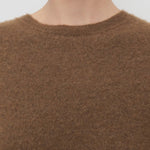Front closeup of oak lorynna top on model against a white background.