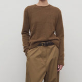Front view of oak lorynna top on model wearing camel trousers and brown belt, against a white background.