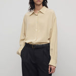 Front view of butter luka shirt on model wearing black pants, against a white background.