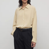 Front view of butter luka shirt on model wearing black pants, against a white background.