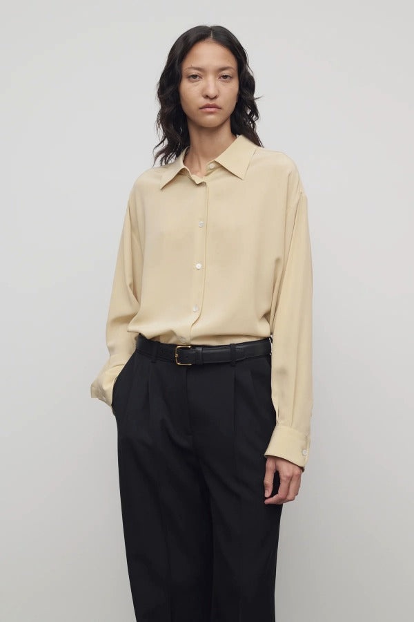 Front view of butter luka shirt on model wearing black pants, against a white background.