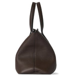 Side view of deep brown marcel bag on white background, with no model shown.