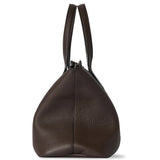 Side view of deep brown marcel bag on white background, with no model shown.