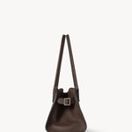 Side view of deep brown margaux shoulder 12 bag on white background, with no model shown.
