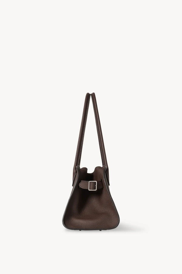 Side view of deep brown margaux shoulder 12 bag on white background, with no model shown.