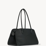 Side slanted view of dark pine margaux shoulder bag on white background, with no model shown.