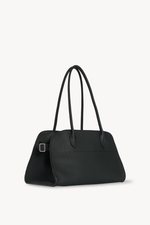 Side slanted view of dark pine margaux shoulder bag on white background, with no model shown.