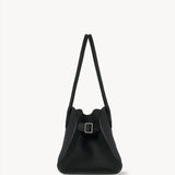 Side view of dark pine margaux shoulder 12 bag on white background, with no model shown.