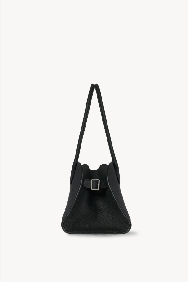 Side view of dark pine margaux shoulder 12 bag on white background, with no model shown.