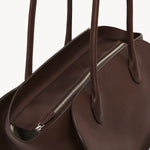 Zipper view of deep brown marlo 14 bag on white background, with no model shown.