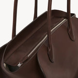 Inside zip view of deep brown marlo 14 bag on white background, with no model shown.