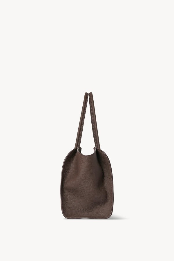 Side view of deep brown marlo 14 bag on white background, with no model shown.