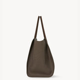 Side view of taupe marlo 17 bag on white background, with no model shown.