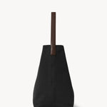 Side view of black medium n/s park tote on white background, with no model shown.
