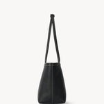 Side view of black medium park tote on white background, with no model shown.