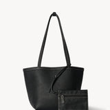 Front view of black medium park tote with zipper pouch on white background, with no model shown.