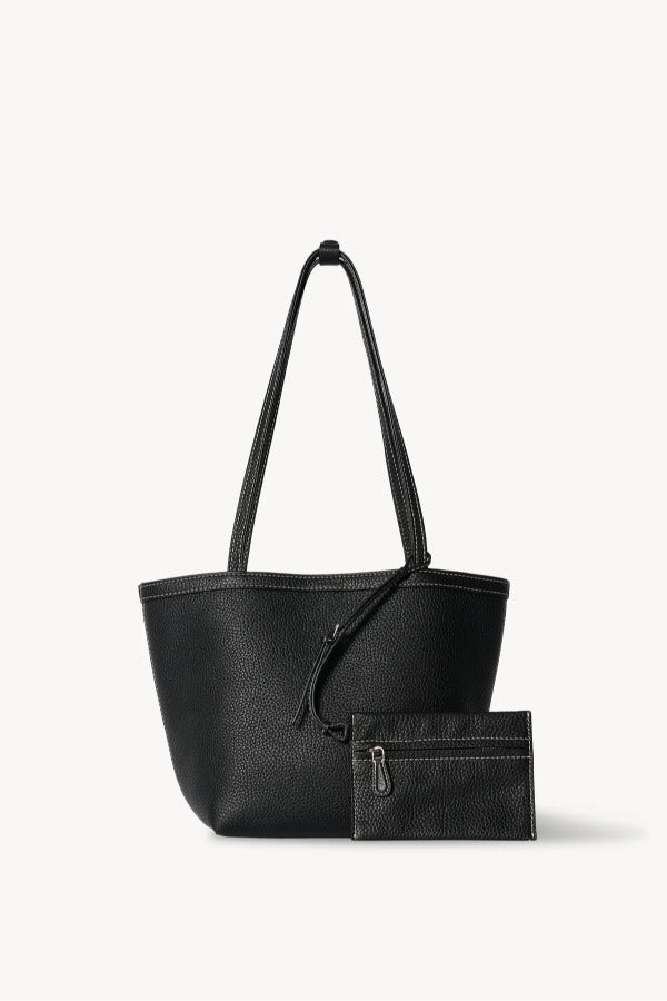 Front view of black medium park tote with zipper pouch on white background, with no model shown.