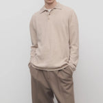 Front view of beige melange almot sweater on model wearing khaki pants, against a white background.