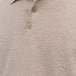 Front closeup view of beige melange almot sweater on model, against a white background.