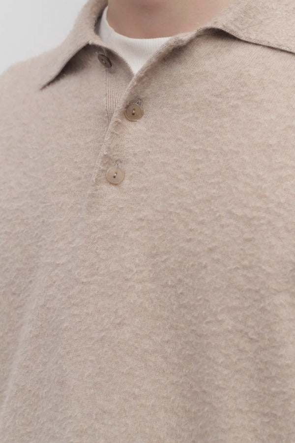 Front closeup view of beige melange almot sweater on model, against a white background.