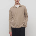 Front view of taupe men's franz sweater on model wearing black trousers, against a white background.