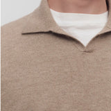Front closeup view of taupe men's franz sweater on model wearing white undershirt, against a white background.