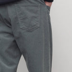 Back closesup view of grey men's fred pants on model wearing black sweater, against white background.